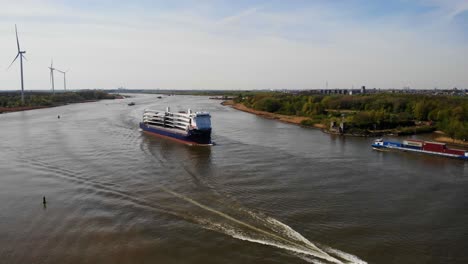 Aerial-View-Of-Symphony-Provider-Cargo-Ship-Approaching-River-Bend-On-Oude-Maas-In-Barendrecht-With-Other-Vessels-Passing-By
