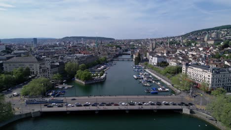 Static-drone-4k-clip-of-busy-Quai-Bridge-crossing-the-Limmat-river-in-Zurich,-Switzerland