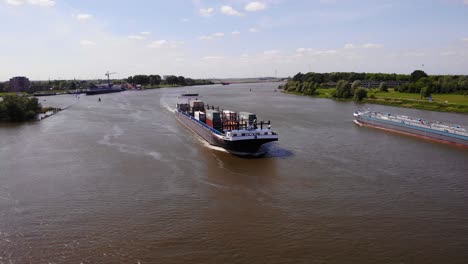 Aerial-View-Of-Missouri-Cargo-Ship-Passing-Another-Vessel-Along-Oude-Maas