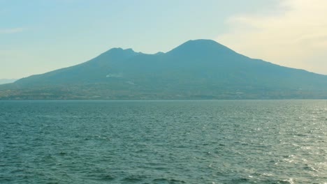 Stunning-view-of-the-Mediterranean-Sea-with-crystal-clear-blue-water-and-Mount-Vesuvius-in-the-background-filmed-from-a-boat-going-in-Italy