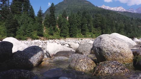 Close-up-shot-of-big-rocks-with-flowing-river-stream-on-them