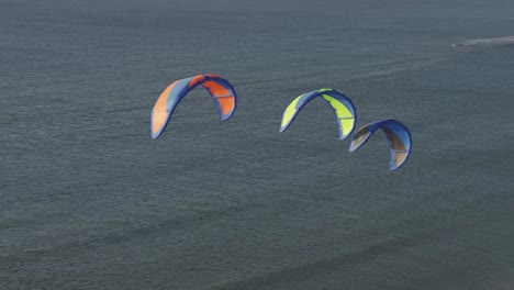Three-colorful-power-kites-flying-in-the-air-above-a-seascape