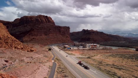 Entering-Moab-Utah-along-Highway-191-on-a-cloudy-day,-aerial