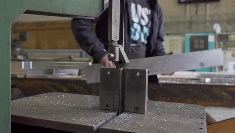 Man-Removing-Cut-Aluminum-From-A-Bandsaw,-Metal-Manufacturing-Production