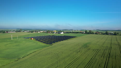 Aerial-View-Of-Agricultural-Fields-With-Solar-Panels-In-The-Countryside