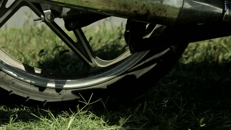Close-up-of-motorcycle-wheel-stopping-and-foot-getting-off-bike