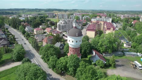 Aerial-shot-of-urban-polish-landscape-with-touristic-water-tower-focused