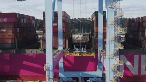 Large-Industrial-Crane-For-Cargo-Containers-At-Husky-Terminal-In-Tacoma,-Washington---drone-descending