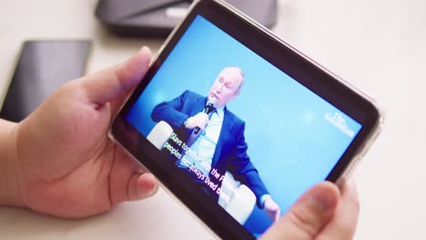 Watching-the-Russian-President-Vladimir-Putin-on-News-and-giving-a-speech-online-on-the-tablet