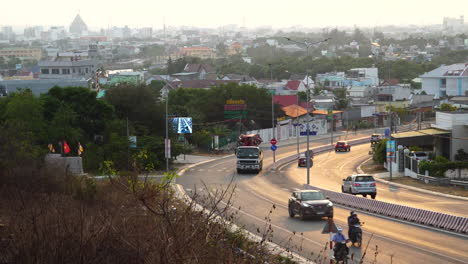 Flowing-traffic-on-a-road-to-Phan-Thiet-with-propaganda-video-on-side