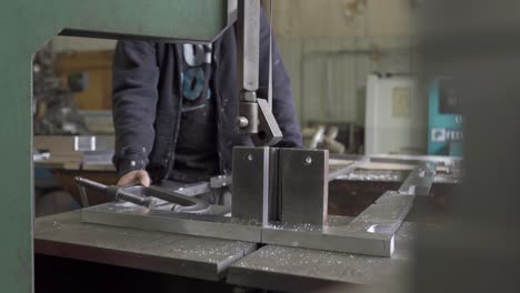 Metalworker-Cutting-Aluminium-In-A-Industrial-Manufacturing-Plant