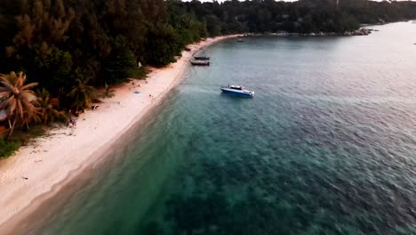 Aerial-Flying-Over-Along-Koh-Lipe-With-Moored-Longtail-Boats-During-Sunset