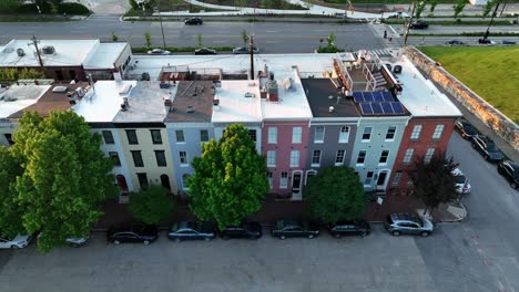 Colorful-rowhouses-aerial-reveal-to-city-skyline-in-USA