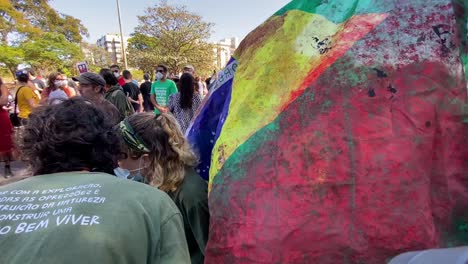 Ein-Mädchen-Blickt-Auf-Die-Zerfetzte-Und-Blutbefleckte-Nationalflagge-Brasiliens-Beim-Protest-Gegen-Die-Morde-Im-Amazonasgebiet-An-Dem-Brasilianer-Bruno-Pereira-Und-Dem-Briten-Dom-Phillips