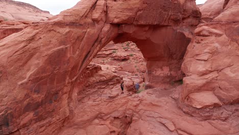 Aerial-view-of-a-couple-exploring-rock-formations-in-Utah