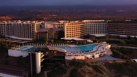 A-drone-shot-of-the-entrance-of-the-luxurious-hotel-standing-on-the-along-side-of-the-ocean