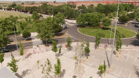 Few-cars-driving-around-roundabout-in-Spain,-aerial-fly-over-view