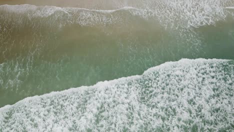 Waves-lapping-up-shoreline-of-Wrightsville-beach-people-relaxing