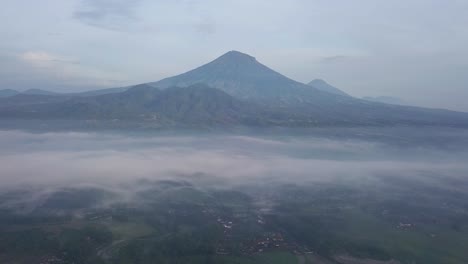 Mystic-Aerial-flight-over-tropical-landscape-covered-with-fog-during-sunny-and-cloudy-day