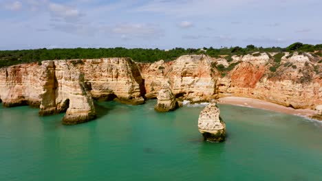 Drone-footage-from-Praia-da-Marinha,-one-of-the-most-famous-locations-on-the-Algarve-coast
