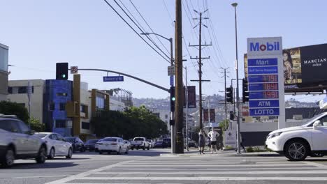 Cars-driving-past-a-gas-station-in-Los-Angeles,-CA-with-the-most-expensive-gas-in-the-United-States