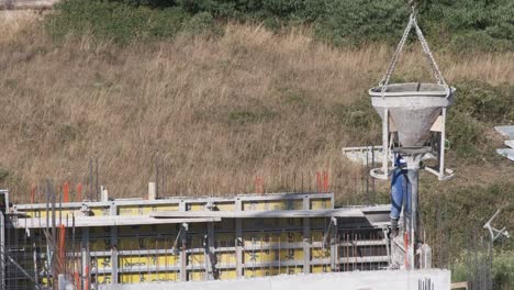 A-men-working-on-a-construction-site-with-a-cement-crane-during-heatwave-in-Zadar,-Croatia-in-July