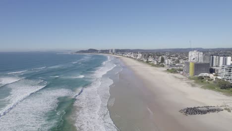 Aerial-View-Of-Empty-Sandy-Beach-And-Oceanfront-Hotels-At-Summer-In-Palm-Beach,-QLD,-Australia