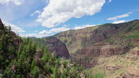 Aerial-Shot-Flying-Backwards-Over-Alpine-Forest-Canyon-Gorge-Cliff-Near-Glenwood-Canyon-Colorado-USA