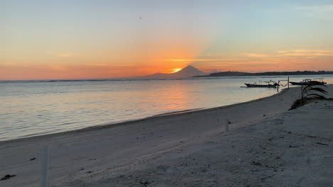 Orange-Sunset-Behind-Mount-Agung-Viewed-From-Beach