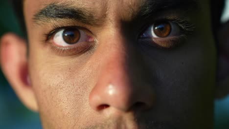 Macro-closeup-of-young-Srilankan-man-opening-eyes,-dramatic-portrait,-day