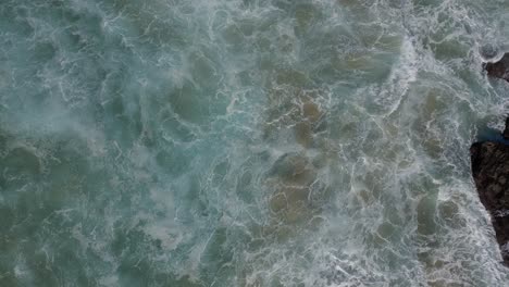 Ascending-reveals-aerial-shot-of-epic-waves-crashing-the-coastline-rocks