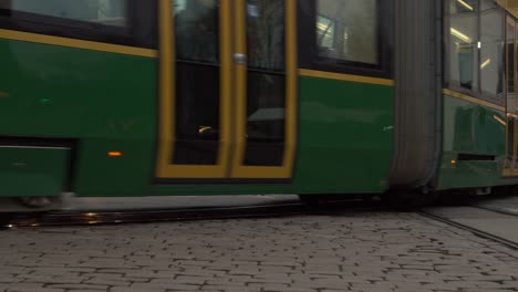 Articulated-street-car-tram-rides-rails-in-city-cobble-stone-streets