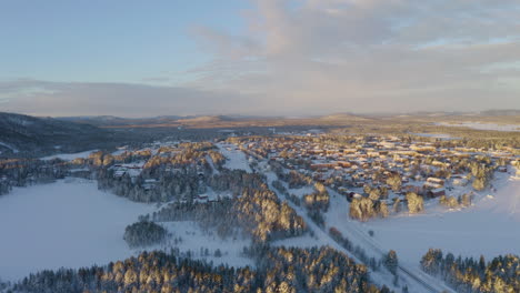 Scenic-sunrise-aerial-view-across-snowy-frozen-Norbotten-Lapland-winter-mountains-landscape