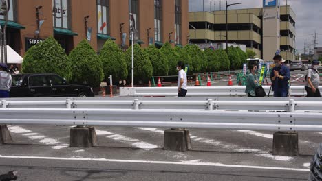 Shinzo-Abe-Speech-and-Assassination-Location,-Lone-Officer-Stands-as-People-Pray