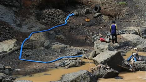 two-men-pick-up-sand-from-the-river-and-put-it-on-the-outskirts-of-the-river,-Sukabumi,-Indonesia,-May-12,-2022