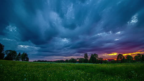 A-brilliantly-colorful-sunset-on-an-overcast-day-over-a-field-of-wildflowers---wide-angle-time-lapse
