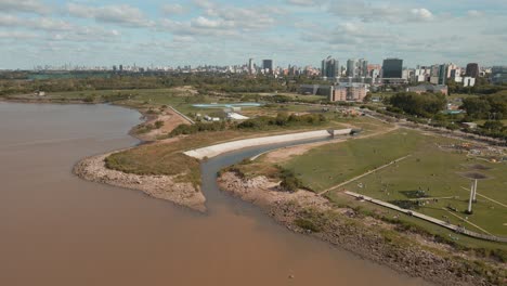 Aerial-establishing-shot-of-Vicente-Lopez-coastal-walk-with-Buenos-Aires-city-behind