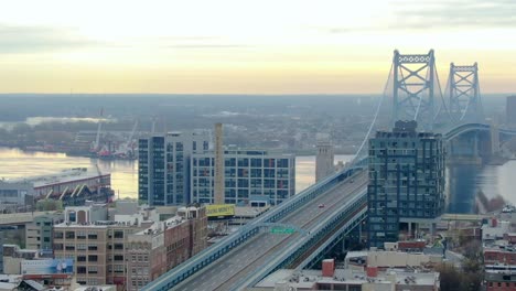Aerial-view-of-quiet-Ben-Franklin-Bridge,-Coronavirus-lockdown,-in-Philadelphia---tracking,-drone-shot