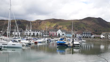 Yachts-and-sailboats-moored-under-luxury-Conwy-serene-mountainous-marina-waterfront-North-Wales