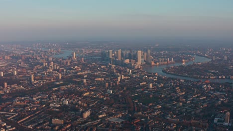 High-altitude-drone-shot-of-Canary-Wharf-and-tower-hamlets-at-sunset