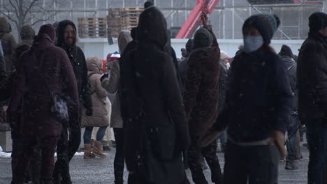 Shot-of-a-group-of-people-dancing-during-the-covid-19-protests-in-Helsinki,-cold-snowy-day