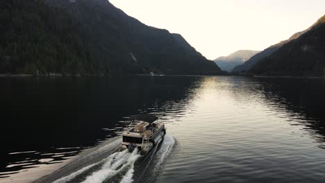 Drone-shot-following-boat-in-Indian-Arm,-an-ocean-in-Vancouver,-Canada