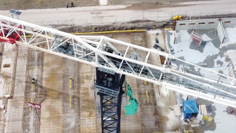 Police-arresting-people-on-top-of-construction-crane-tower,-Working-On-Tower-Crane-Boom-In-Netherlands-With-Industrial-Buildings-of-wageningen-university-In-Background