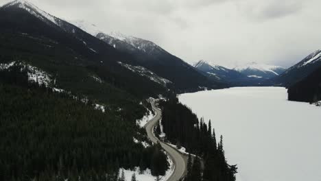 Drone-aerial-shot-of-frozen-Duffey-Lake-in-British-Columbia,-Canada