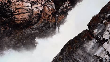 Slow-motion-shot-of-waterfall-and-rock-at-Nairn-Falls-Park-in-British-Columbia,-Canada