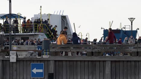 Crowd-of-People-Leaves-Ferry-Docked-in-Harbor-on-a-Sunny-Day-in-Klaipeda