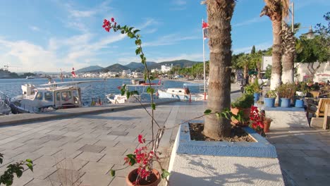 People-strolling-along-Bodrum-promenade-overlooking-Aegean-Sea,-Turkey