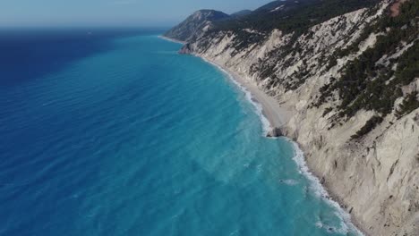 Aerial-cinematic-shot-of-the-coastline-of-Lefkada-with-beautiful-turquoise-water-at-Egremni-popular-beach