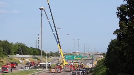 Cranes-trying-to-turn-back-an-overturned-oil-tanker-while-firefighters-closely-monitor-the-situation