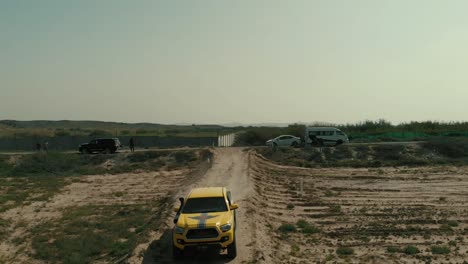 Yellow-4x4-Truck-Riding-Along-Dirt-Road